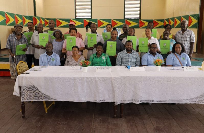 Minister within the Ministry of Agriculture Hon. Valarie Yearwood, to her left are: GLSC’S Managers Mr. Durwin Humphrey, Mr. Cyphil Swan and Mrs. Jewel Cheong. To her right are Mr. Julian Benons, Senior Land Administration Officer for region 10 and Ms. Elsie McPherson, pose with the new leaseholders.