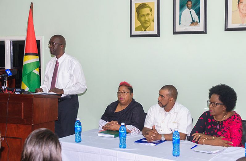 GLSC Commissioner and Chief Executive Officer (CEO), Trevor Benn addressing reporters in the presence of Chairperson of GLSC Board of Directors, Paulette Henry (extreme left) and two senior officials attached to the commission