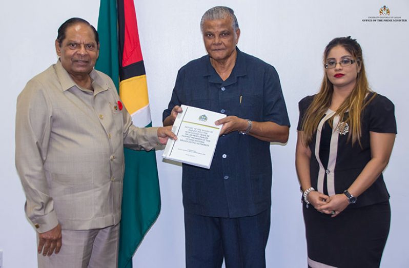 Prime Minister Moses Nagamootoo receiving the CoI report from Major General (ret’d) Joseph Singh on Friday at the Office of the Prime Minister. Also in photo (right) is Legal Advisor from the Ministry of the Presidency, Geeta Chandan-Edmond
