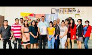 CEO of Nand Persaud & Company Ltd Mohindra Persaud with his staff following the handing over of the certificate