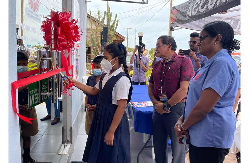 Executive Director (ag) of the GNBS, Ms. Ramrattie Karan and Regional Chairman, Bryan Allicock, looks on as pupils of the Arapaima Primary School cut the ceremonial ribbon