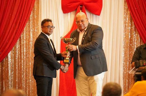 CEO of GNIC, Gobind Persaud (left), accepts the award from Vice Chairman of the Shipping Association of Guyana, Allan Newark