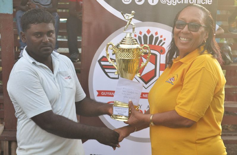 General Manager (ag) Guyana Chronicle, Donna Todd presenting the winner’s trophy to No.72 All stars captain.