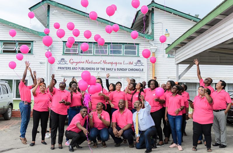 Staff members releasing balloons outside of the compound to honour the lives lost to Breast Cancer and the survivors of the disease (Photos by Delano Williams)