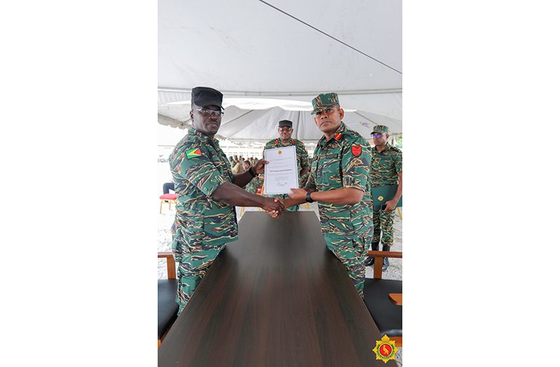 Chief-of-Staff, Brigadier Omar Khan, formally issues Lieutenant Colonel Lloyd Souvenir his new appointment letter as GNR Commandant