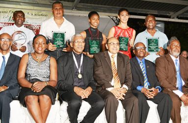 (Standing) L-R Award winners, representative of Buxton Youth Development Organisation, Sean Devers, Larissa Wiltshire, Taylor Fernandes and  Carl Ince. 
 (Sitting): President David Granger third from left is   flanked  by Garfield Wiltshire, Minister Nicolette Henry, GOA President K. Juman  Yassin, Ivor O’Brien and Hector Edwards