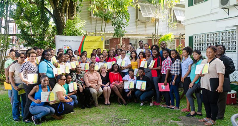 The participants pose with their certificates, sitting are (from left) GOA President K. A. Juman-Yassin, GOA VP, Dr. Karen Pilgrim, UNICEF Representative to Guyana and Suriname, Marianne Flach, and Minister responsible for Sport, Nicollette Henry