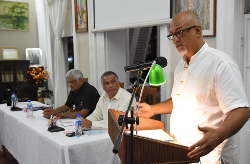 Human Rights and Conflict Resolution Specialist, Lawrence Lachmansingh, speaks at the podium at Moray House. Seated nearby from left are former Association of Caribbean Media Workers (ACM) President, Wesley Gibbings and former Guyana Elections Commission (GECOM) Chairman, Dr. Steve Surujbally (Samuel Maughn photo)