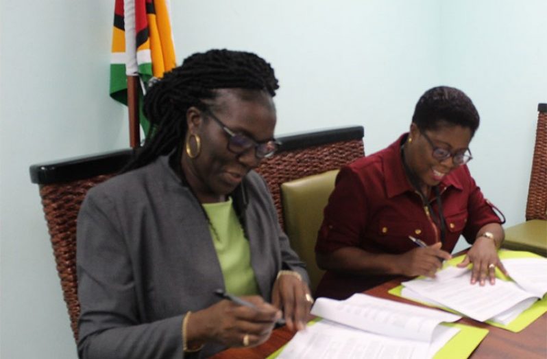 Permanent Secretary of the Ministry of the Presidency, Ms. Abena Moore (left) and Commissioner of the Protected Areas Commission, Mrs. Denise Fraser (right), signing the agreement for the implementation of the Guyana Protected Areas System, Phase III (GPAS III), in the Boardroom of the Ministry of the Presidency, Shiv Chanderpaul Drive, Georgetown.