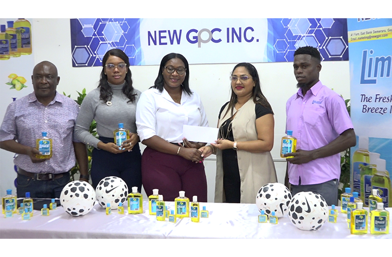 New GPC Inc Marketing Manager Elizabeth Ram presenting the cheque to Petra's Jackie Boodie in the presence of other officials