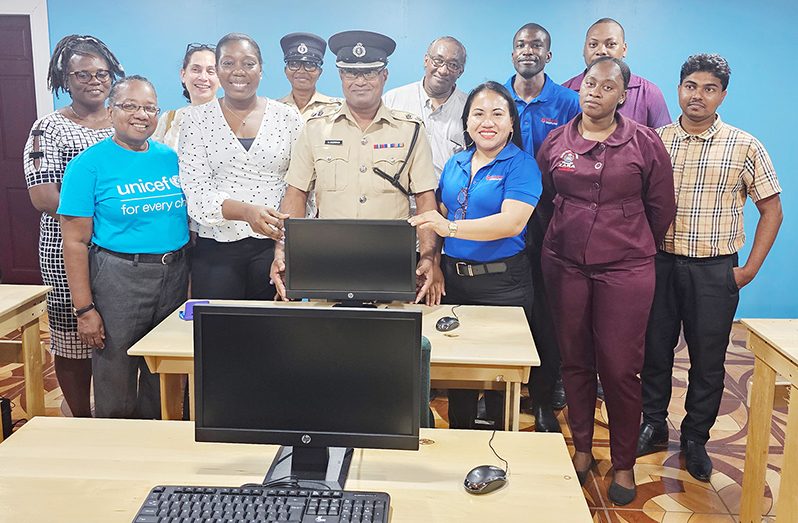 Commander of Region Six, Senior Superintendent Shivpersaud Bacchus, (centre) flanked by Penny Francis from Starr Computers Corporate Sales & Marketing (third from right at front) along with other officials at the Guyana Police Force Academy Berbice Campus