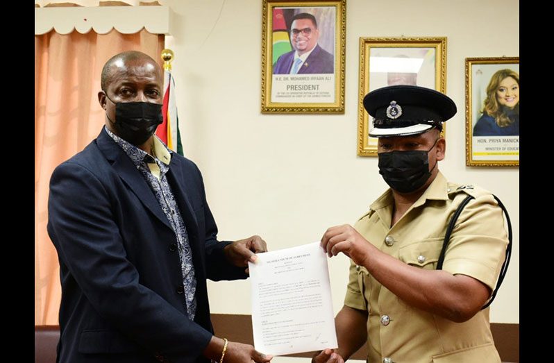 PS King and Commander Brutus hold a copy of the MoU (GPF photo)