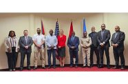 Minister of Home Affairs, Robeson Benn (fourth from left) together with US Ambassador to Guyana, Nicole Theriot (fifth from left), and Lt. Col. Michael Jones (fifth from right), Executive Director, CARICOM IMPACS, as well as other participants at the CGIU sensitisation and awareness workshop in Guyana