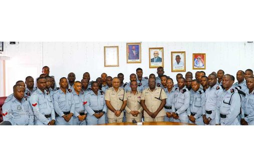 Commissioner of Police, Clifton Hicken (centre), alongside Deputy Commissioners Ravindradat Budhram and Errol Watts, flanked by ranks of the Force's SWAT Unit