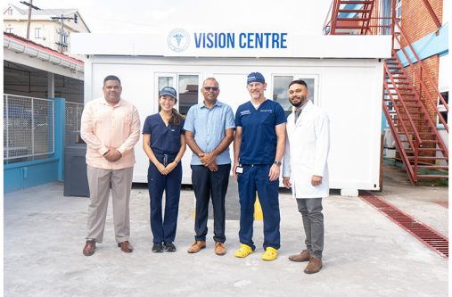Chief Executive Officer (CEO) of the GPHC, Robbie Rambarran; Minister of Health, Dr Frank Anthony (Centre); Director of the Duke Global Ophthalmology Program, Dr. Lloyd Williams (second from right), alongside local and visiting medical professionals and officials, outside the Vision Centre at GPHC.