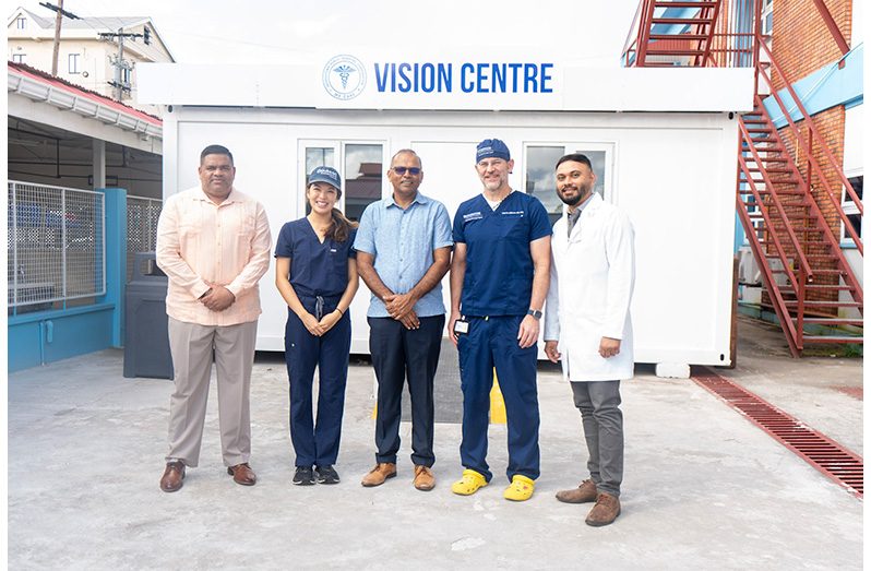 Chief Executive Officer (CEO) of the GPHC, Robbie Rambarran; Minister of Health, Dr Frank Anthony (Centre); Director of the Duke Global Ophthalmology Program, Dr. Lloyd Williams (second from right), alongside local and visiting medical professionals and officials, outside the Vision Centre at GPHC.