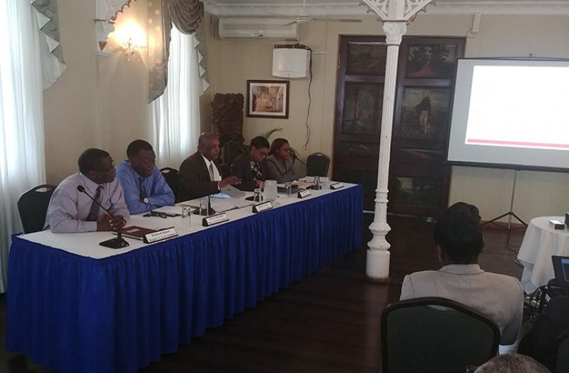 GPL CEO Albert Gordon (centre) flanked by his deputies and senior officials at the PUC hearing at Cara Lodge
