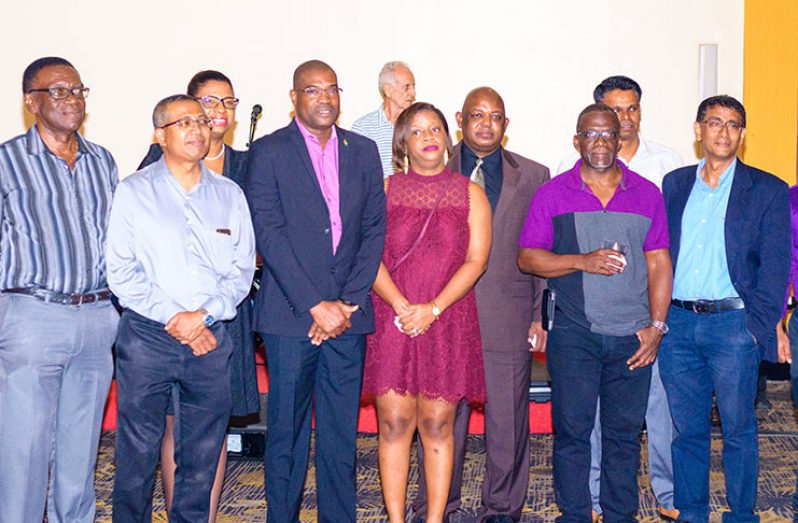 Minister of Public Infrastructure, David Patterson(second left) stands with the new CEO of GPL, Albert Gordon and staff of the power company