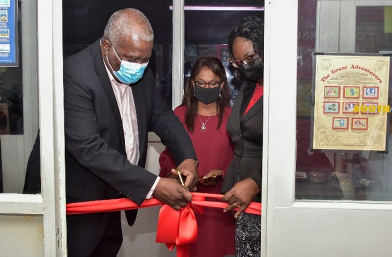 Prime Minister Brigadier (Ret'd) Mark Phillips and other officials cut the ceremonial ribbon to officially commission the Philatelic Library at the GPOC, on Thursday