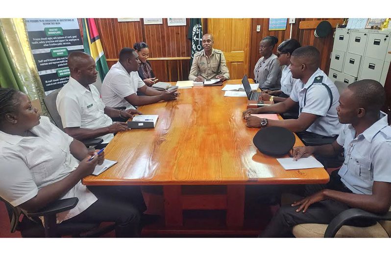 Director of Prisons, Nicklon Elliot (centre), with agriculture officers from various prison locations at the Prison Headquarters