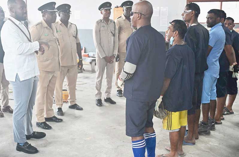 Minister of Labour and Manpower Planning, Keoma Griffith, interacts with inmates, in the presence of senior and technical officers of the Ministry and GPS, at the Lusignan Prison