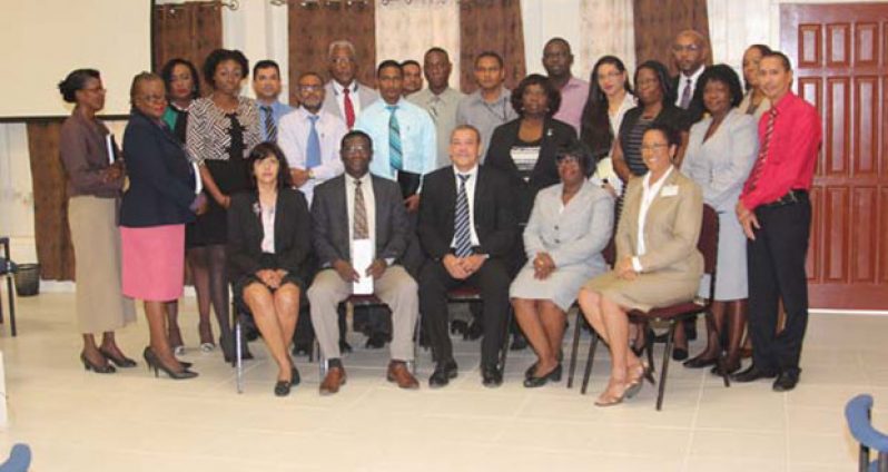 GRA’s Commissioner-General Godfrey Statia (seated centre) sits with staff of the Revenue Authority including Chairman of the entity’s board Rawle Lucas (seated second left) and Ingrid Griffith (seated second right)