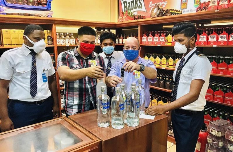 GRA officers affixing the stamp on bottles