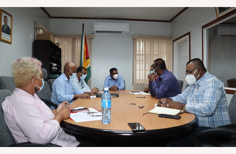 Minister of Agriculture, Zulfikar Mustapha (centre) in discussion with officials of the Guyana Rice Development Board and CEO of Nand Persaud and Company Limited, Mohindra Persaud