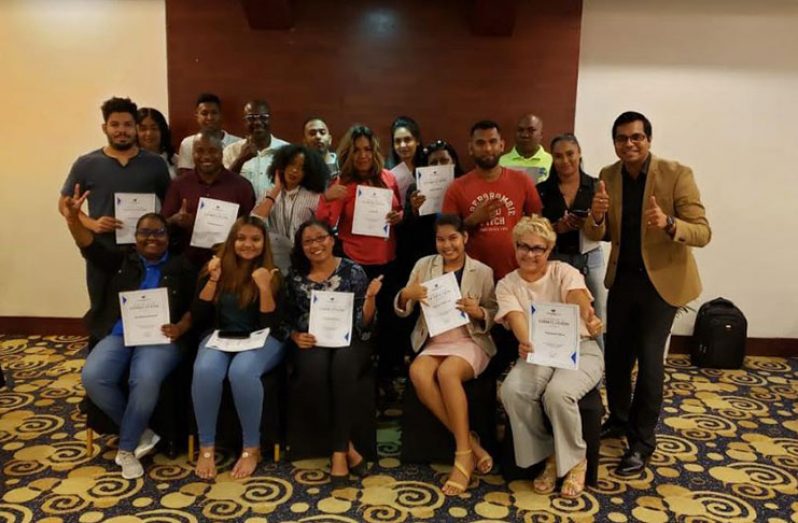 Participants display the certificates they received at the completion of the two-day  training course. At right is course facilitator Rosh Khan (Photos courtesy of the GTA)