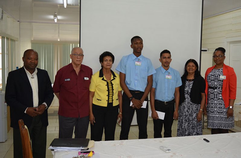(From left to right) Assistant Chief Education Officer (Technical), Patrick Chinedu Onwugmia, Major-General (rtd), Norman McLean, Sylvia Conway (board member, Gafoor Foundation), students Emani Charles and Joshau Bharrat; Gafoor Foundation Board member Ameena Gafoor and acting GTI Principal, Renita Crandon-Duncan after the presentation