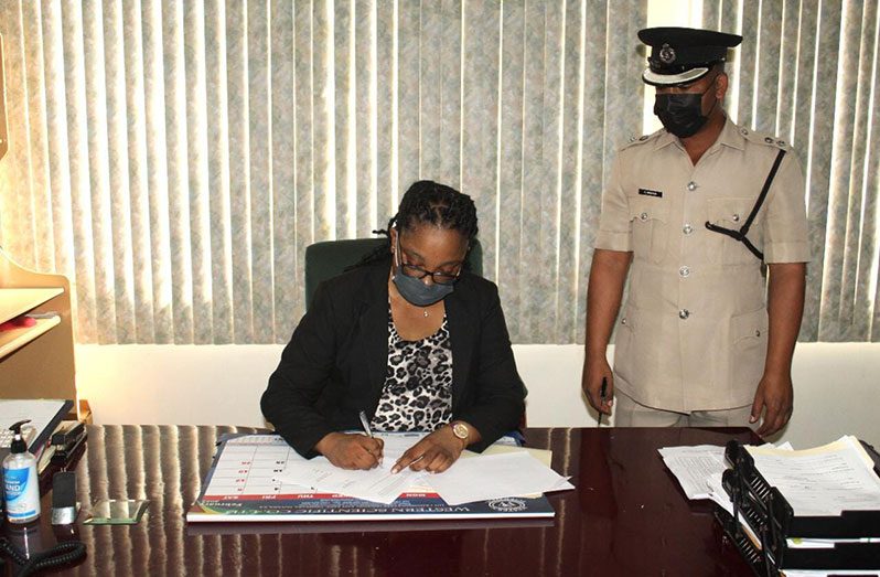GTI Principal, Dr. Renita Crandon-Duncan signs the agreement with Deputy Commissioner (Administration) (ag.), Calvin Brutus