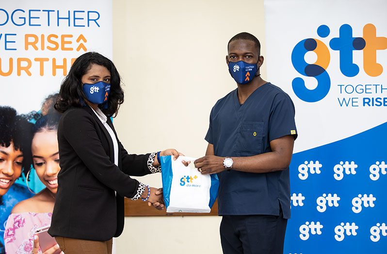 Dr. Abel Caesar receiving one of the handsets from Product Marketing Manager at GTT, Ubrina Khan