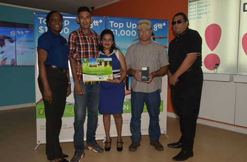 GTT GTT Director of Retail Sales Allison Dundas (left) and Fly Jamaica’s Commercial Manager Carl Bowen (right), with promotion winners George Mahase and his wife and consolation winner, Paul Fernandes