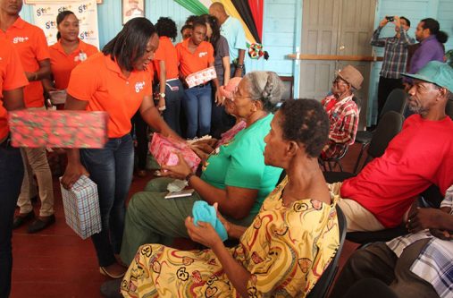 GTT staff distributing gifts to  residents of the Palms