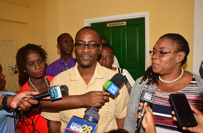 Guyana Teachers’ Union (GTU) President Mark Lyte and General Secretary Coretta McDonald, speak with the media in the courtyard of the Ministry of Social Protection on Tuesday (Adrian Narine photo)