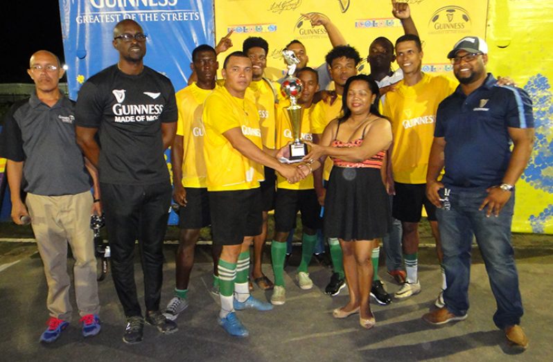 The Disconnection Crew receives their trophy after defeating Goal-Raiders 1-0 in the final.