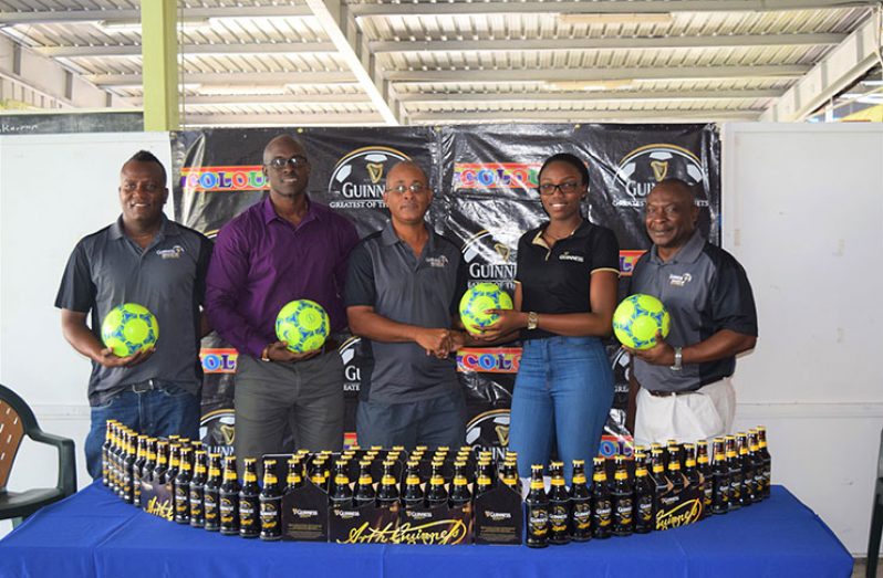 Three Peat Promotions’ Rawle Welch (2nd from left), collects the symbolic ball from Colours Boutique representative Creanna Damon in the presence of Referees Coordinator Wayne Griffith (left), Guinness Brand Manager Lee Baptiste (2nd from left) and Banks DIH Limited Communication Director and tournament consultant Troy Peters.