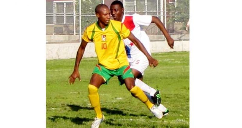 Anthony ‘Awo’ Abrams being closely marked by a Panamanian defender during their clash, as Guyana went on to win 8-1. (Photo compliments of www.caribbeancupsoccer.com)