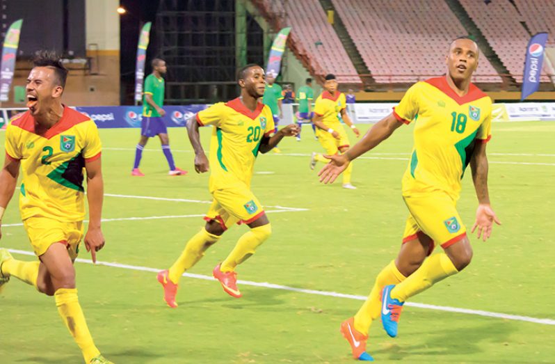 FLASHBACK! Neil Danns (first from left) celebrates after scoring his second goal against St Vincent and the Grenadines at the Guyana National Stadium. Also in photo, from left,  are Samuel Cox and Trayon Bobb. (Samuel Maughn photo)