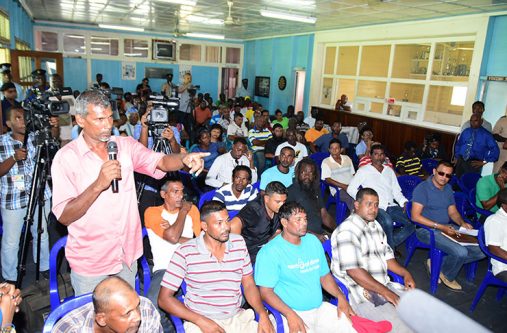 A cane harvester making a point during the meeting