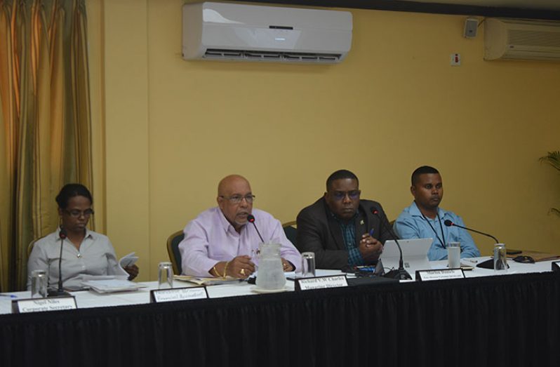 GWI Chief Executive Officer (CEO) Dr Richard Van West-Charles (second left) addresses concerns of the Public Utilities Commission (PUC) and the public at the Cara Lodge on Wednesday