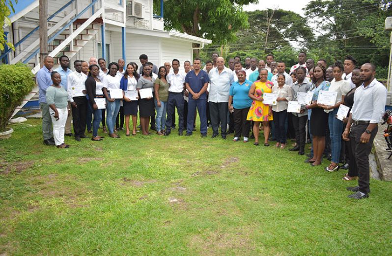 Participants of the training pose for a photo with members of GWI's Management and EMS team