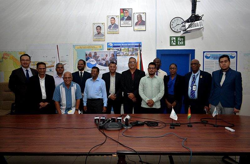 Minister of Housing and Water, Collin Croal; GWI’s CEO, Shaik Baksh, along with the contractors and members of the GWI Board, following the signing of the contracts for the seven new water-treatment facilities (Elvin Carl Croker photo)