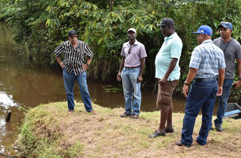 GWI officials near the Kaituma River where traces of mercury were discovered (DPI photo)