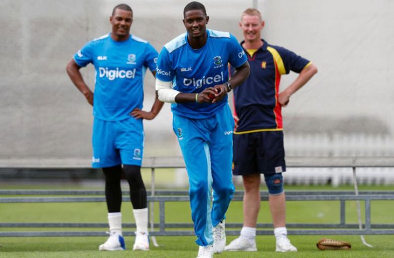 West Indies' Shannon Gabriel (L) watches as team captain Jason Holder bowls during a training session at Lord's cricket ground in London, on September 5, 2017, ahead of their third Test match against England. (AFP Photo/Adrian Dennis)