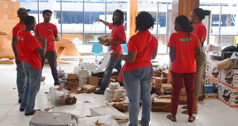 Staff of the Gafoors Houston Complex sort items which were saved from the fire