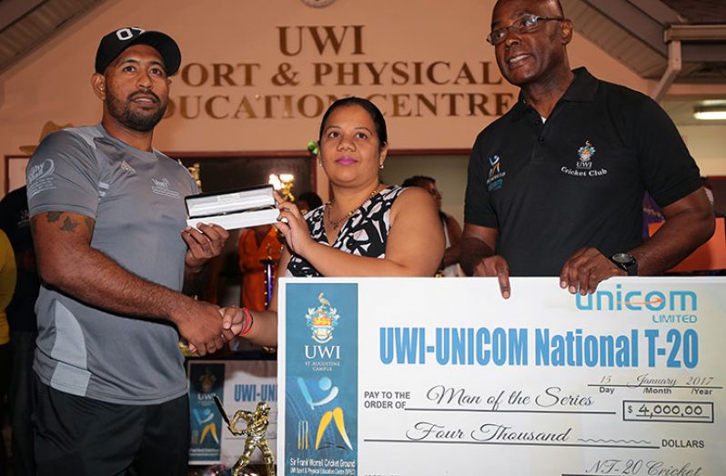 DCC's Gajanand Singh (left) receives gold chain and pendant for his UWI UNICOM T20 Player-of-the-Series award plus TT$4000 from UWI Registrar Richard Saunders.
