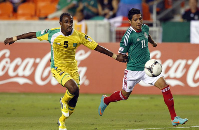 FLASHBACK! Javier Aquino (#11) fights off Guyana’s Walter Moore in the first half at BBVA Compass Stadium on October 12, 2012 in Houston, Texas.