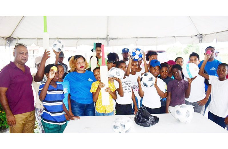 Deputy Commissioner ' Operations '(ag.), Ravindradat Budhram (extreme left) with youths from Diamond, East Bank Demerara that benefitted from the GPF engagement within their community