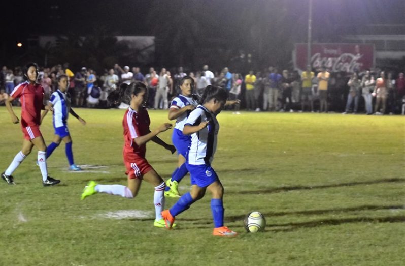 A Paruima forward (in blue) on the attack against Region 9's Gladiators FC (in red) during the final of the Female Football competition at the Indigenous Heritage Games. (Samuel Maughn Photograph)